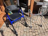 Blue OasisSpace rollator and silver Lightweight Drive walker side by side on a patio with brick flooring