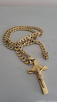 Image showing the gold plated 24 inch chain with the crucifix pendant attached, laying flat.