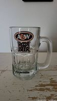 Front view of clear A&W Root Beer glass mug showing logo and thick handle.