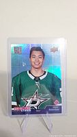 Front of 2020-21 Upper Deck Jason Robertson rookie card showing player image in green Dallas Stars uniform with holographic background.