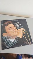 Front cover of the vinyl LP showing Johnny Cash singing and the album title with a list of songs.