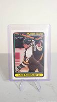 Front of the Mike Modano rookie card showing player in North Stars uniform in action, protected in plastic case.