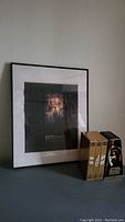 Framed Star Wars Episode VI movie poster with black matting and thin black frame, shown next to the VHS box set.