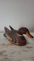 Front side view of the wood duck decoy showing detailed carving and painting
