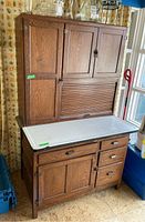 Full front view of two-piece oak hoosier style hutch showing upper and lower sections