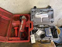 Two power tools in their cases: Red Milwaukee 4.5 inch sander grinder with side handle and gray Dremel 4000 rotary tool with accessories and case.