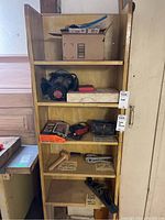 Full shelf view showing multiple vintage tools and boxes including Stanley plane, router and other items