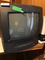 Frontal view showing curved CRT screen, front VCR door and GE logo