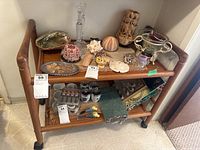 Front view showing full two-tier cart with various items on shelves