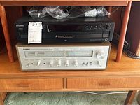 Sony CDP-CE375 CD player on top and Yamaha CR-400 stereo receiver below on wooden stand