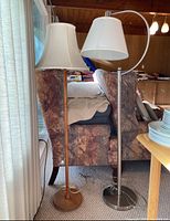 Both floor lamps side by side, wood and metal models shown