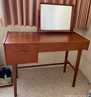 Front view of complete teak dressing table with attached pivoting mirror