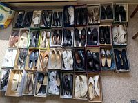 Overview of 41 pairs of women's shoes in boxes, showing a variety of styles including heels, loafers, pumps, and sneakers all for narrow feet size 8 AA.