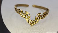 Front view of open cuff bracelet showing detailed filigree work