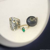 Front-side view of all three rings showing detailed designs and stones.