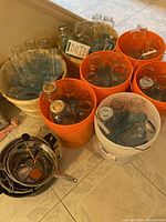 Overall view of glass jars in wooden bushel and plastic buckets