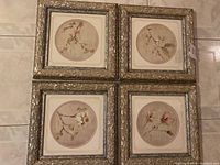 Four framed botanical prints of Dogwood, Apple, Cherry, and Magnolia flowers in ornate silver-toned carved frames.