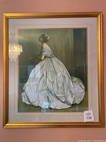 Front view of framed print showing woman in white gown seated in profile, gold frame and double matting