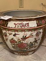 Full side view of large porcelain planter showing floral and bird motif
