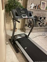 Full image of NordicTrack treadmill showing the running belt, frame, and console with digital screen and control buttons.