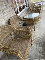 Four chairs and table arranged on porch