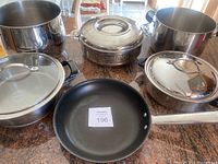 Overview of pots and pans: a large stockpot, a covered stainless steel pot, a non-stick frying pan, a Thermapot steamer.