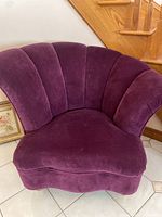 Front view of purple scalloped accent chair.