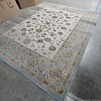 Full view of the floral area rug showing the entire pattern and border.