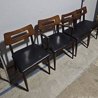 Four chairs in a row, showing overall lot and one with arms