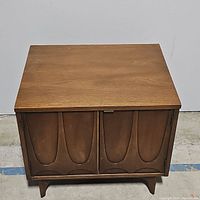 Front view showing sculpted double doors and overall finish