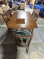 Overall shot of dining table with leaf and chairs