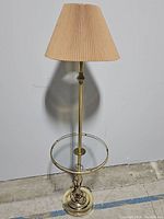 Full view of the vintage brass lamp table with pleated beige shade showing design and height.