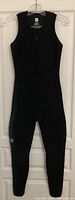 Full view of the black sleeveless wetsuit on a hanger showing front zipper and coverage area.