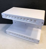 White plastic solar LED sign light with two rows of LEDs, embossed Enlogik logo on the side.