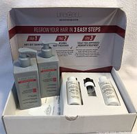 Photo showing complete boxed set with shampoo, conditioner, and topical solutions for hair restoration.