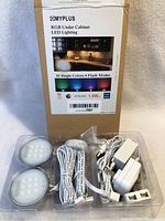 Overall pack showing four LED lights with wires, two power adapters, and connectors in plastic packaging with box behind.