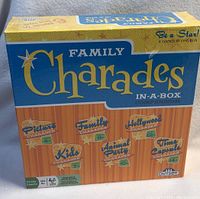 Front side of the box showing the Family Charades In-A-Box Compendium game with details of included games and age suitability.