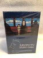 Front of sealed box showing Studio Ghibli characters and branding, indicating 100 collectible postcards inside.