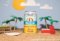 Promotional can of Dominion City Lite beer on miniature beach scene with palm trees and sand