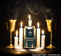 Image of a Dominion City Brewing Co. Moment of Clarity DIPA can surrounded by lit candles and brass goblets
