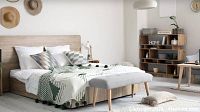 Bedroom rendering with light wood bed frame, neutral bedding, patterned throw and bench