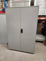 Front exterior view of closed grey metal cabinet