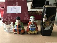 Photo showing the vase, two Moriage porcelain figurines with incense burners, and glass candle holder arranged together.