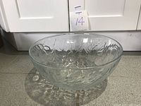 Large textured clear glass bowl photographed from above and side to show size and pattern details.