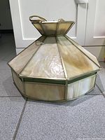 Full view of the milky stained glass ceiling lamp shade showing the octagonal shape and metal framing