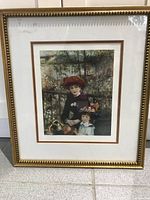 Framed Two Sisters art shop reprint showing full artwork and gold frame on tile floor.