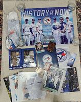Full assortment displayed including posters, bobbleheads, rally towels, autograph photos, cards and books.