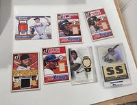 Photo showing seven baseball cards with jersey patches and autograph cards from Donruss series including Base Kings, Jersey King, All-Star Stitches, and Position of Power