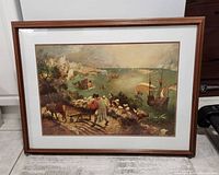 Framed print of "Landscape with the Fall of Icarus" showing full view including medium brown wood frame and white matting.