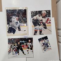 Four autographed photos of NHL players Bryan McCabe, Curtis Joseph, Igor Korolev, and Jere Lehtinen placed on a white background.